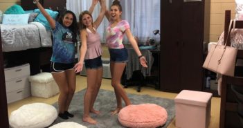 Three Saint Leo University students uplifted by their dorm decorations.