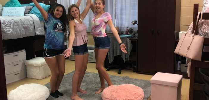 Three Saint Leo University students uplifted by their dorm decorations.