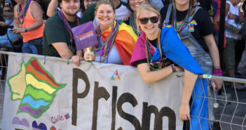 PRISM members holding a PRISM banner.