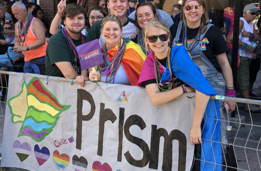 PRISM members holding a PRISM banner.