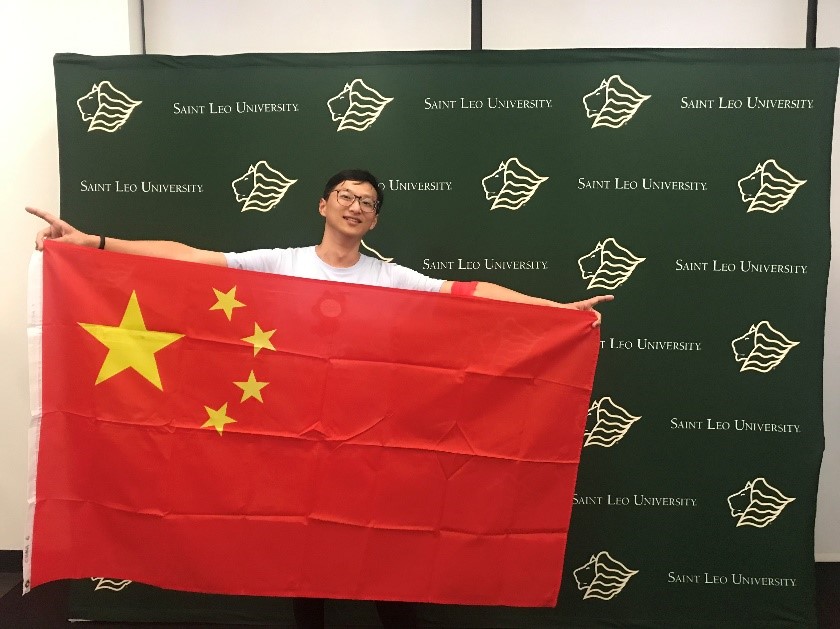 Student holding Chinese flag.