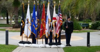 The American flag next to the different Military Branches flags.