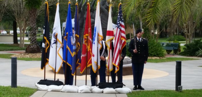 The American flag next to the different Military Branches flags.