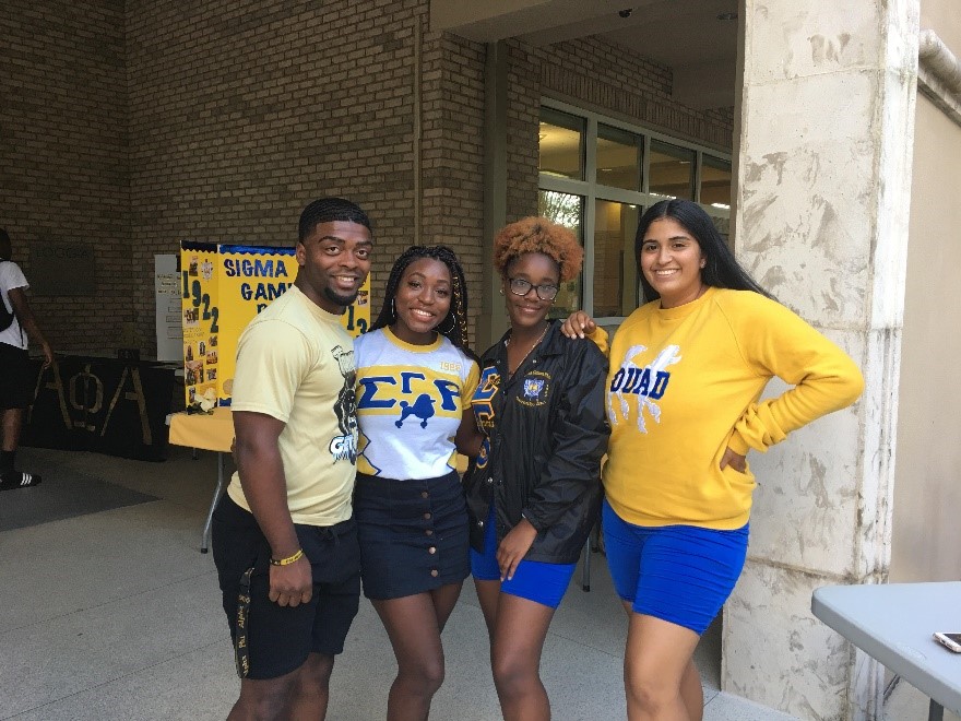 Sigma Gamma Rho members posing outside College of Business