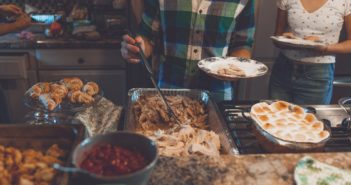 Person picking food on tray