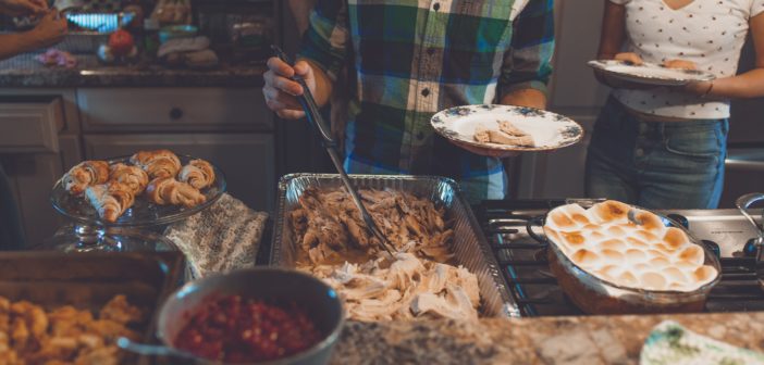 Person picking food on tray