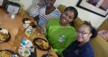 Students eating in a booth in the dining hall