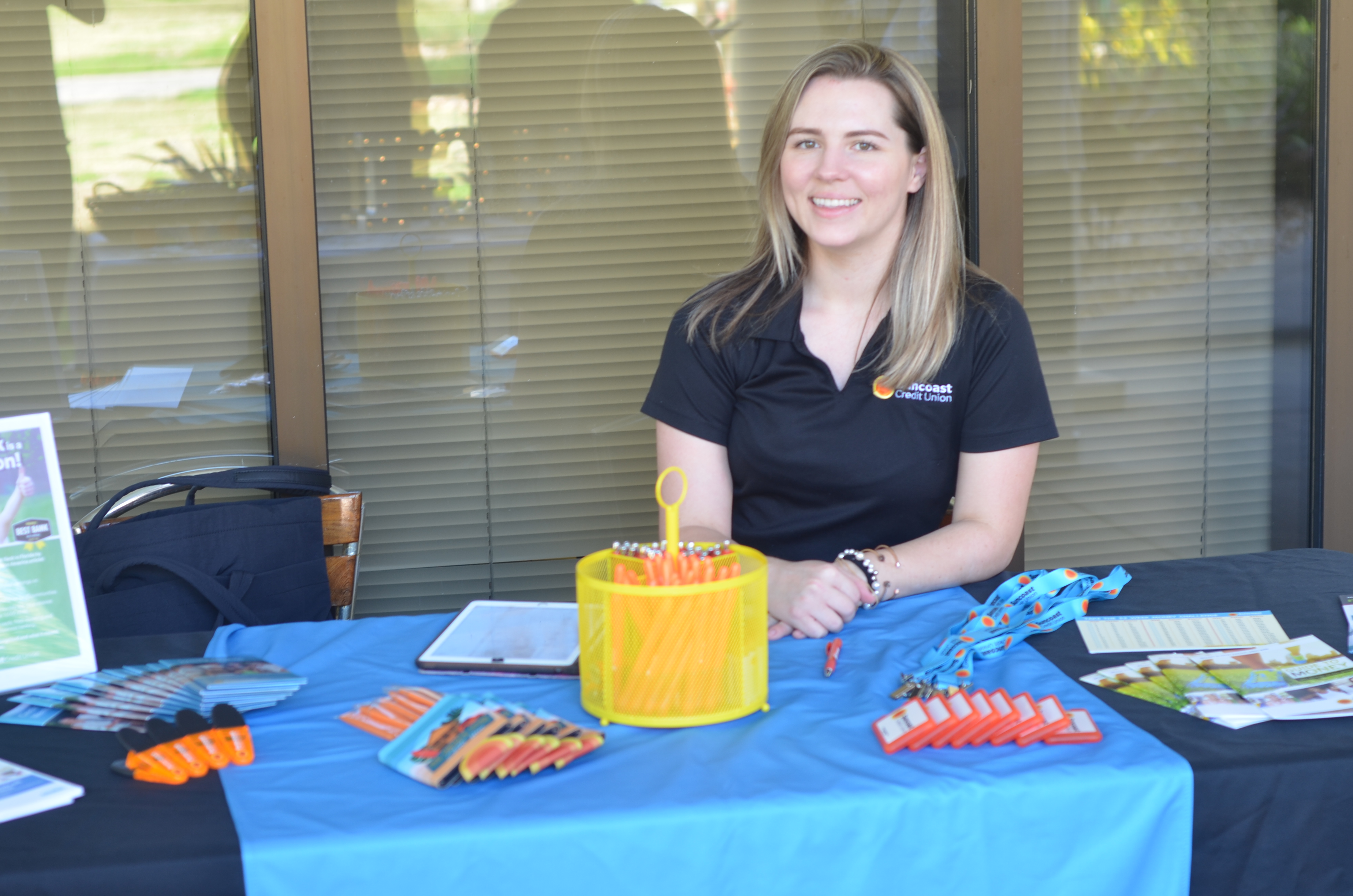 Person sitting next to tabling booth.