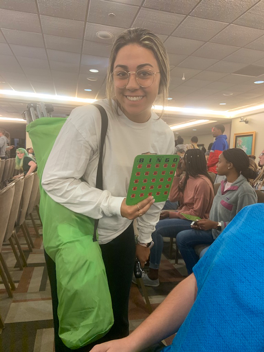 Student holding one of the Bingo green cards.