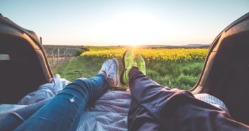 People's feet enjoying spring break sunset