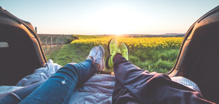 People's feet enjoying spring break sunset