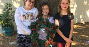 Cut Line: Lucy (left), Sophia (center), and Alida (right) channeled their love of animals through their editorial article about artificial and live trees, asserting that artificial trees are safer for pets.