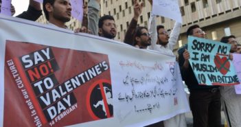 Protesting sign being held by people that reads "Say No To Valentine's Day".