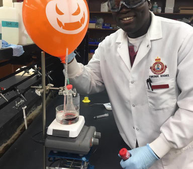 John Hall, Editor-in-chief of TLPMG in lab coat.