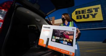 Shopper with tv outside Best Buy store