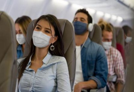 inside of an airplane with passengers wearing masks