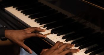 A Black man playing the piano