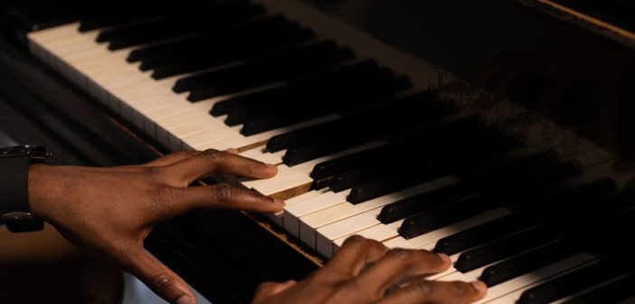 A Black man playing the piano