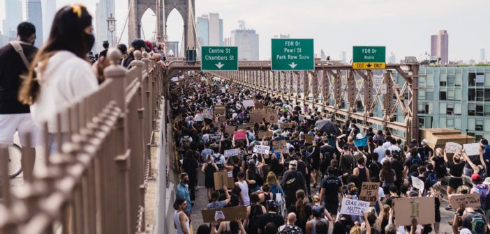 People protesting and blocking a bridge