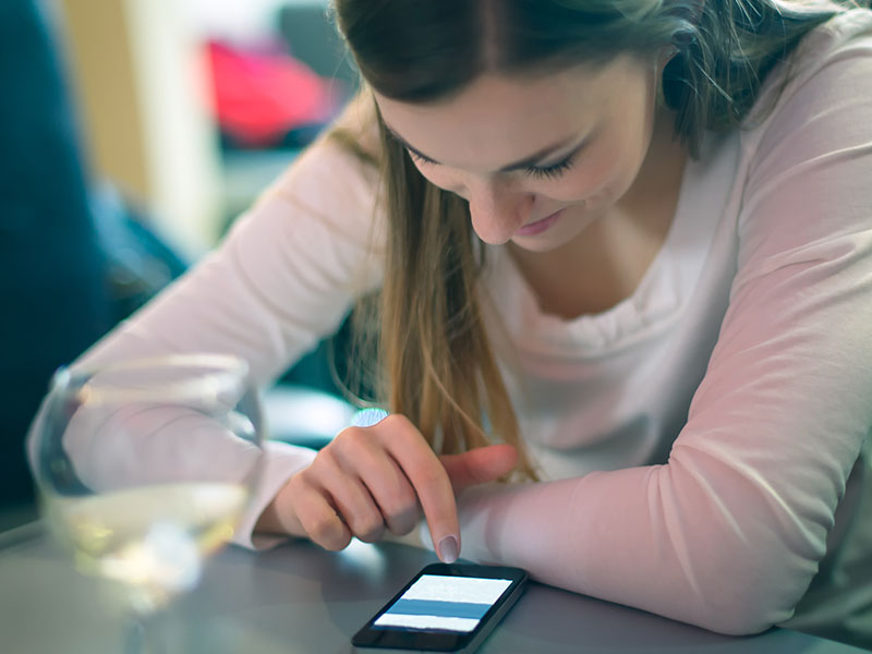 Close up of a woman using a dating app