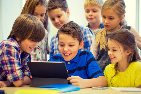 Group of young students looking at a laptop screen