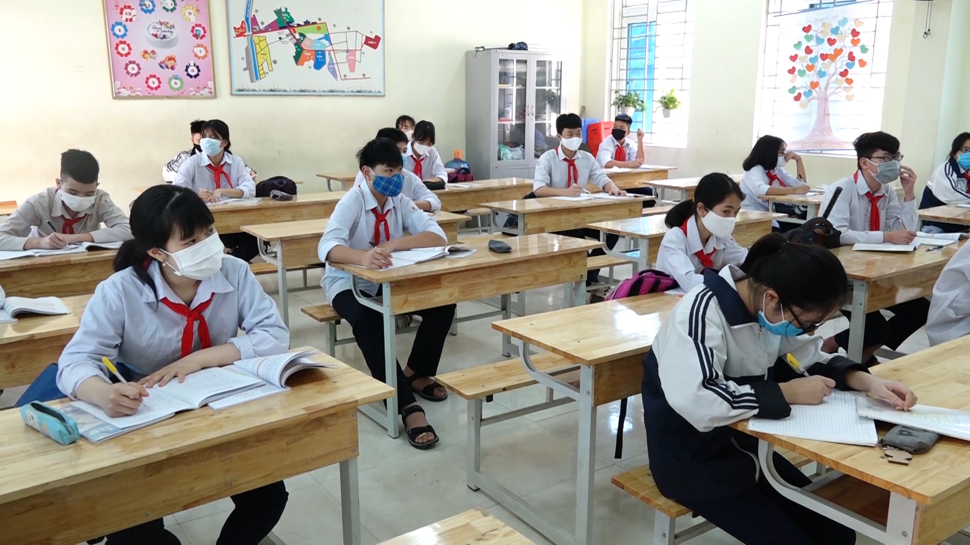 Students sitting at desks with masks on