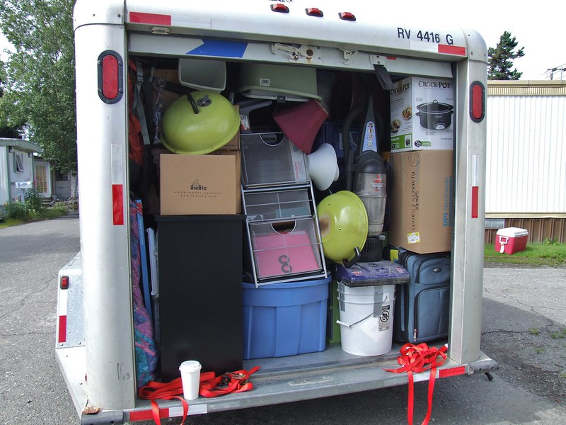 A moving truck filled with boxes and equipment