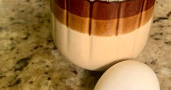 A coffee mug and an egg