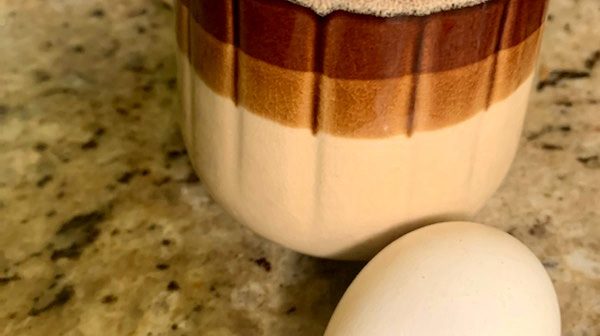 A coffee mug and an egg