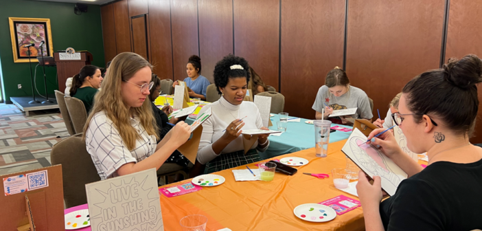 Ryn Williams, a senior majoring in English and medical humanities, and Khamille Labbe, a senior majoring in English, enjoyed the painting activities.